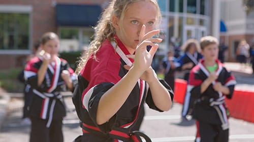 girl doing karate with arms in ready position